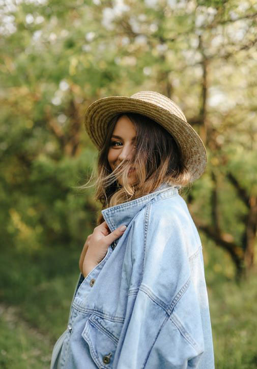 woman with comfortable shirt jacket and hat in outside setting